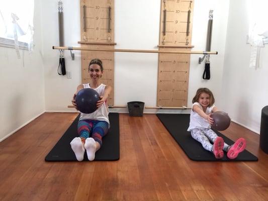 Little Audrey loves doing roll ups with her mom!