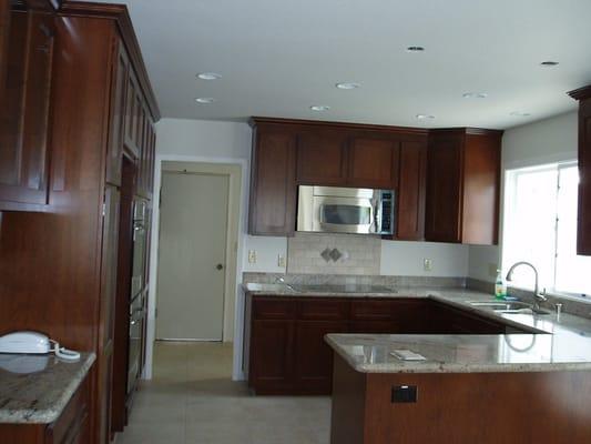 Cherry Kitchen with Granite Tops and Tile Backsplash