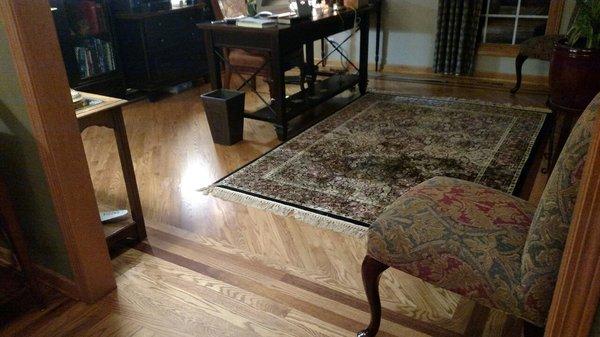 This is the floor that Arthur put in my den.  Red Oak with two strips of Brazilian Cherry inlaid.