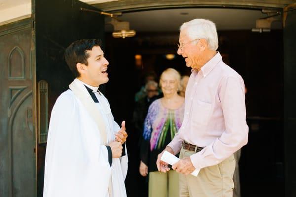 The minister greets people after the service.