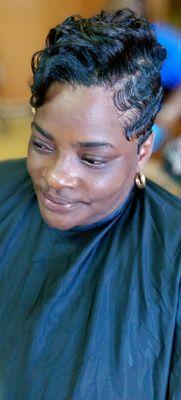 Client has Relaxer short pixie cut with finger waves curled at the top.