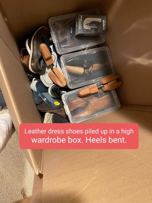 Leather dress shoes piled up in wardrobe box