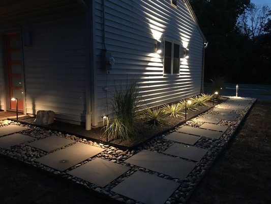 Side and rear elevation with lighting highlighting modern walkway.