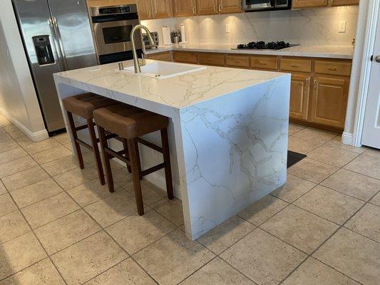 Waterfall Quartz Island, Quartz countertops and Quartz backsplash in kitchen.