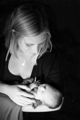 Mom and her newborn love in the comfort of her home.