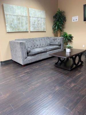 Part of the inner lobby. There are additional chairs lining the opposite wall and a few along the other side of the couch.