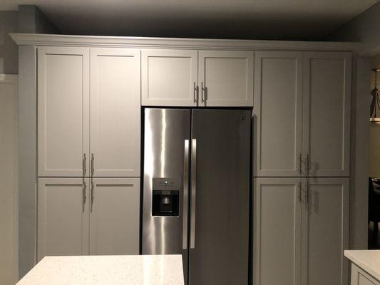 Pantry on each side of the fridge, with pull outs and shelves