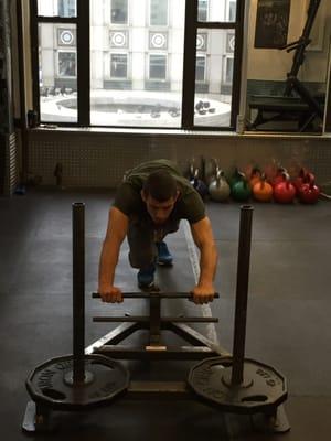 Power sled training to develop rotary stability and explosive power that converts in athletic performance.