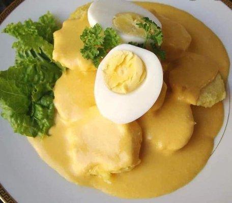 Papa a la Huancaína: Sliced boiled potato topped with creamy spicy yellow pepper cheese sauce