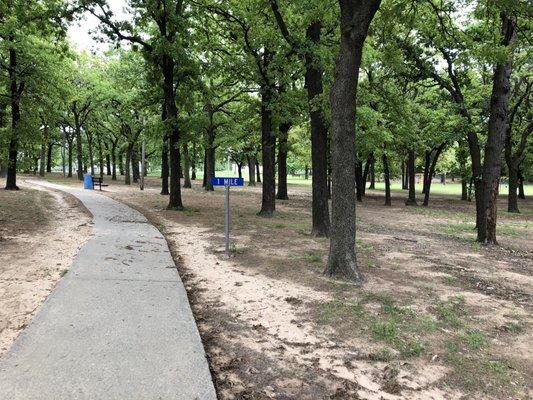 Distance markers for the sidewalk trail around the park.