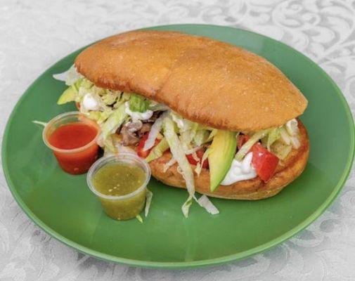 Taqueria Yolandita's Torta Sandwich includes: lettuce, tomatoes, onions, sour cream, Mayo, cheese, avocado, and meat of choice.