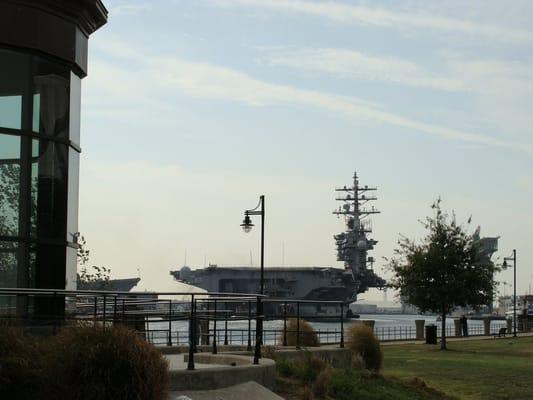 The carrier USS Dwight D. Eisenhower passes by our front doors here at Skipjack located on Portsmouth, Virginia's riverfront.