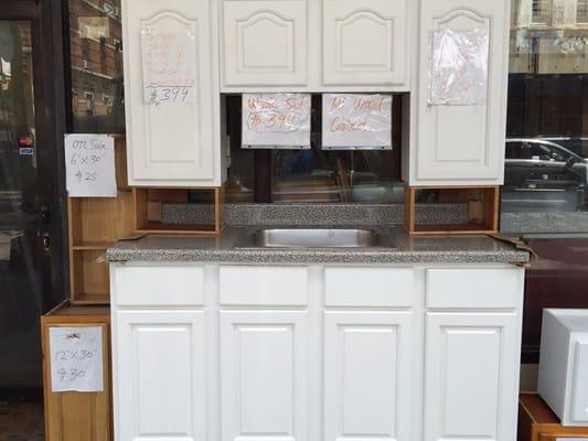 Our $399 5ft Solid Wood Starter Set includes 3 wall cabinets,1 sink base cabinet,one 6" deep sink,and one formica countertop .Oak available.