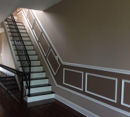 The wrought iron railing, wainscot, paint colors, and finished hardwood floors highlight this area.