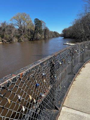 Riverside walkway with colorful locks on the fence