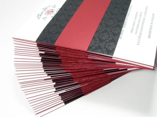 Wedding invitations inspired from a wine bottle label with red hand painted edge and burgundy foil hot press on museum board.