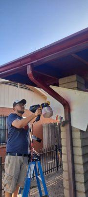 Painting a gutter we installed.