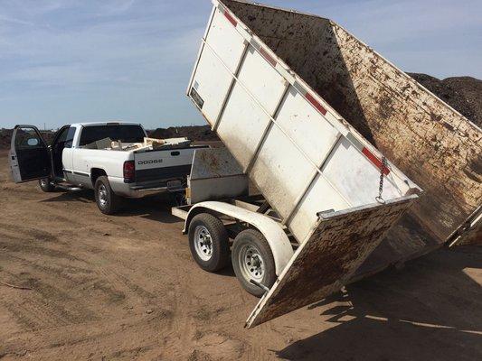 Dump trailer and long bed pickup.