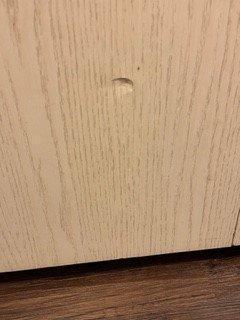 Dented hallway closet in brand new apartment.