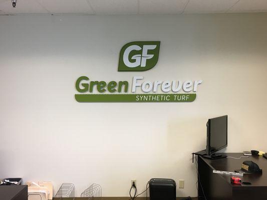 3' x 6' cnc routed mdf logo and lettering with surface paint installed in corporate office on wall