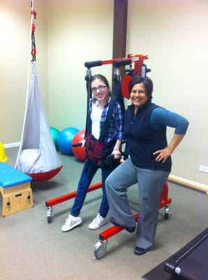 Iymen working with a child on the Lite Gait system.