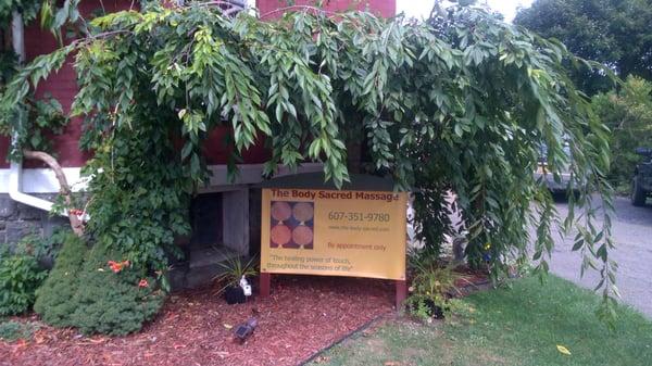 The Body Sacred Massage  Sign by parking lot and entrance