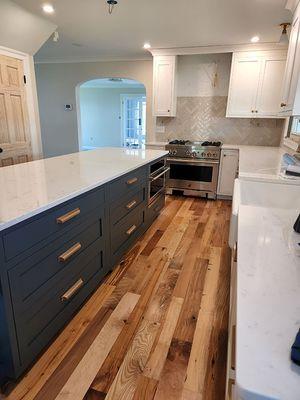 Custom wood flooring and cabinetry in kitchen.