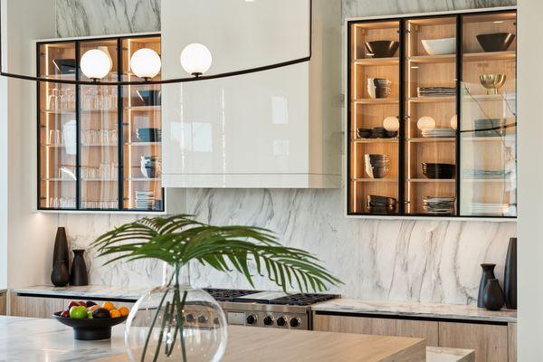 Glass upper cabinets with interiors wrapped in white oak.
Modern Home Interior.