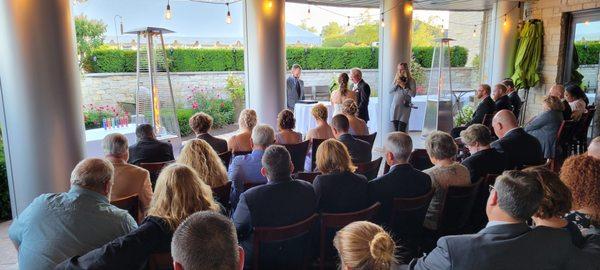 Outdoor ceremony yet under the protection of a roof.