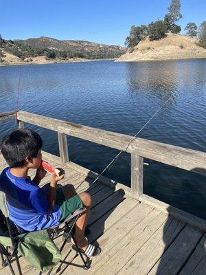 Eating a watermelon while waiting for fish to bite!