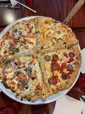 Four seasons pizza! 4 in 1! Each section is divided by breadsticks-bonus! Shrimp, garlic, spinach, tomatoes, sausage, purple onions, etc