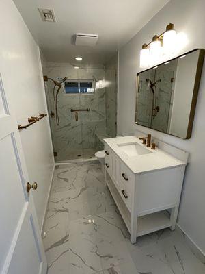 Calacatta Gold tiles with gold hardware. Beautiful bathroom change!!!