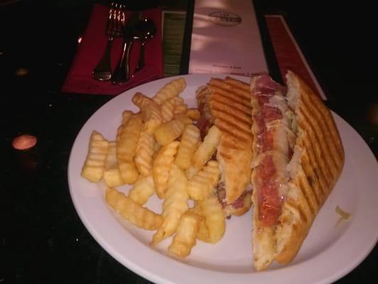 Grilled and melted Godfather Panini with crinkle fries.