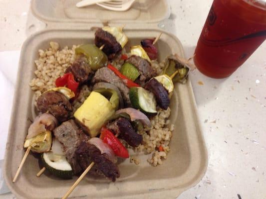 Steak and vegetable kebabs over brown rice