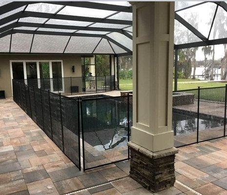 Custom Outdoor Kitchen space with beautiful pavers and stone accent columns.