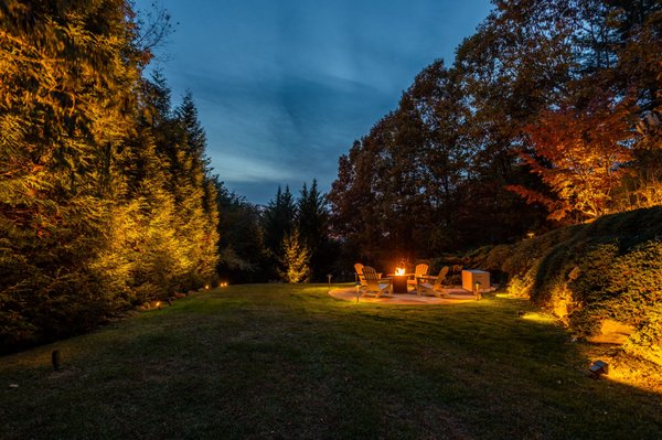 Cozy lighting around a fire pit. Perfect setting for hosting or just sharing the space with family and friends.