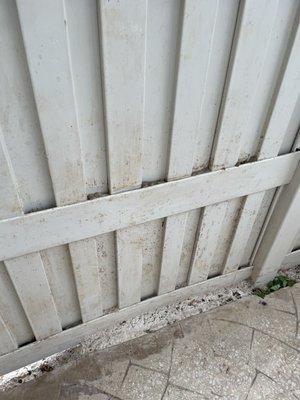 Failed to power wash and clean fence, you can also see the grinded down concrete swept and packed between the slab and fence.