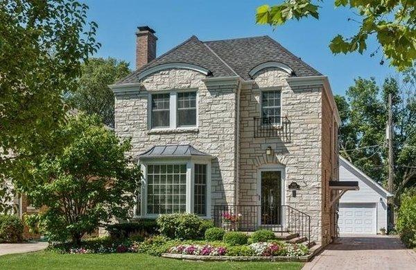 Chicago style stone Georgian featuring architectural shingles.