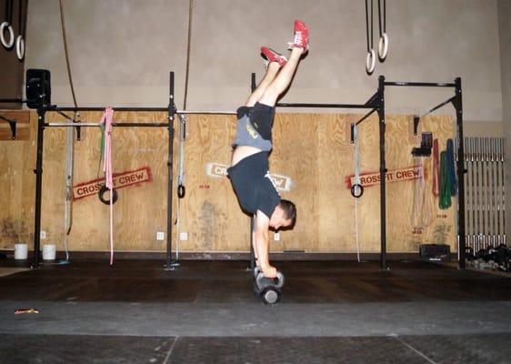 Coach Stephen doing handstand holds on Kettlebells