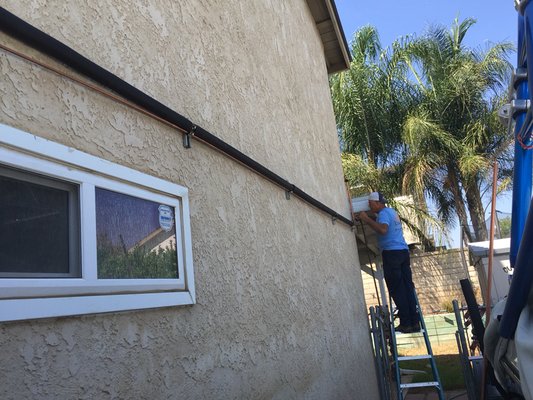 Say hello to Joe who's running cooper refrigerant lines across this homes exterior wall nice and straight.