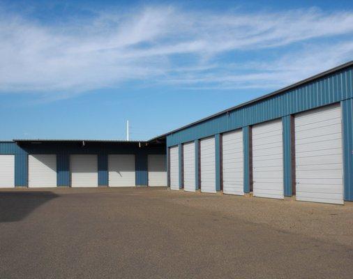 Spacious enclosed bays with concrete floors and 12 foot high walls