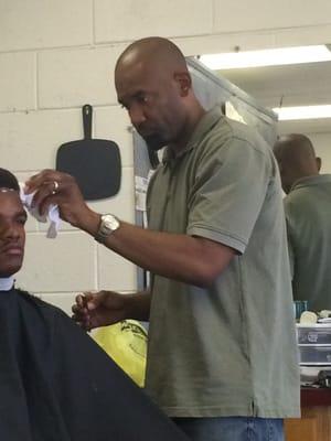 See Mr. Larry-  cuts ethnic hair and blend, fades, Mohawk, Afro and more.  He has a passion for his craft as a barber.