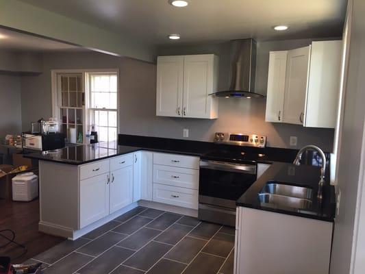 Removed existing wall to expand kitchen are reinforce beams using 2 LVL beams. New lighting, floor, plumbing, and reposition of appliances.