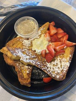 French toast with ricotta cheese strawberries butter sugar and honey.