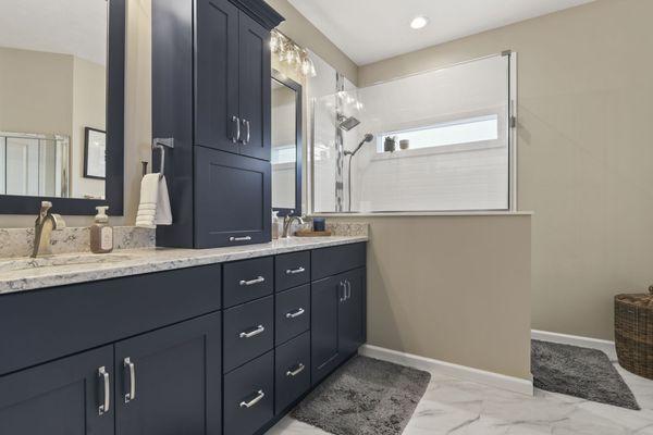 Transitional master bath remodel in Springfield, IL. Lots of storage, large walk in shower, beautiful quartz countertops with double sinks.