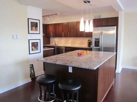 New kitchen in Downtown Chicago includes knocking down walls and installing new cabinets, appliances, lighting and flooring.