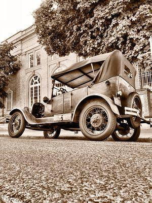 Old car in front of our building.