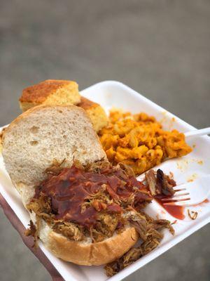 Pulled pork sandwich, mac and cheese, and cornbread.