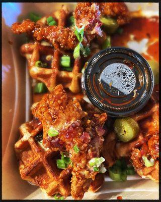 Honey chipotle chicken and waffles with jalepenos and green onions.