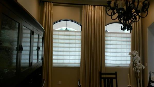 Roman shades with side panels on a raw iron rod